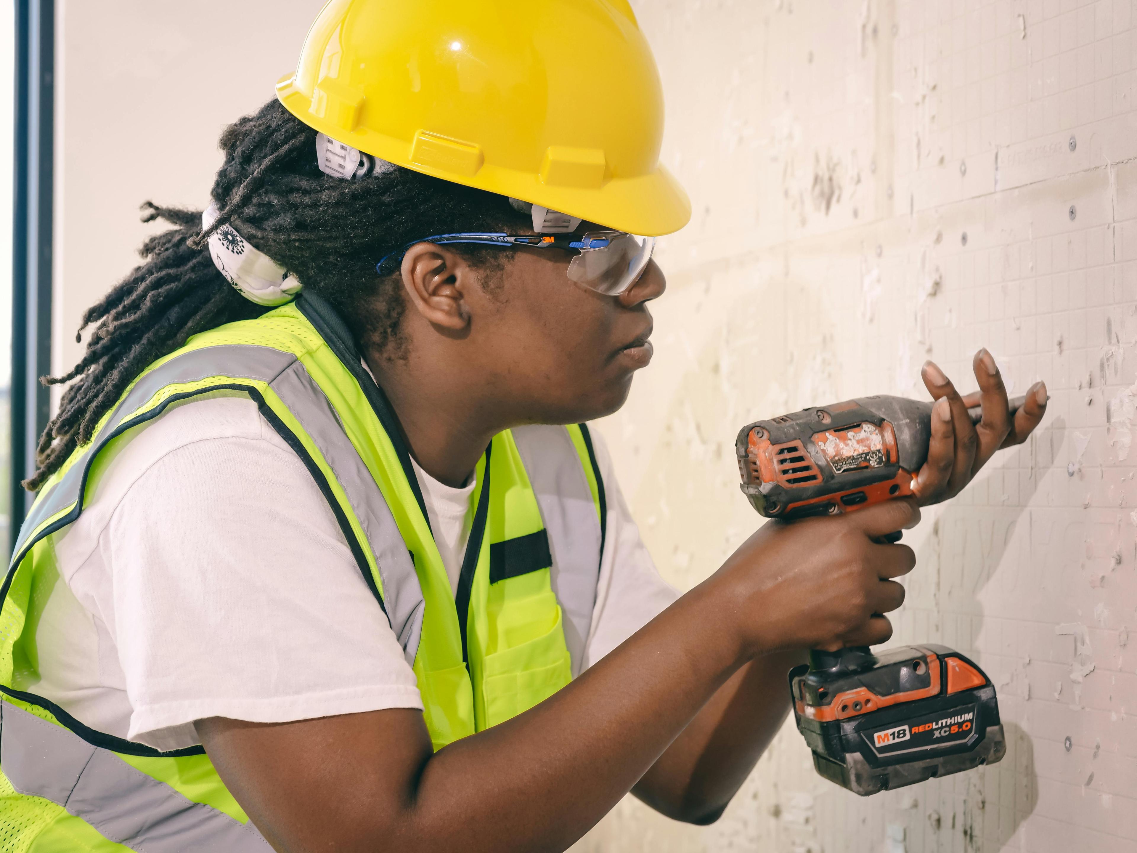 a female plumber holding a plumbing wrench