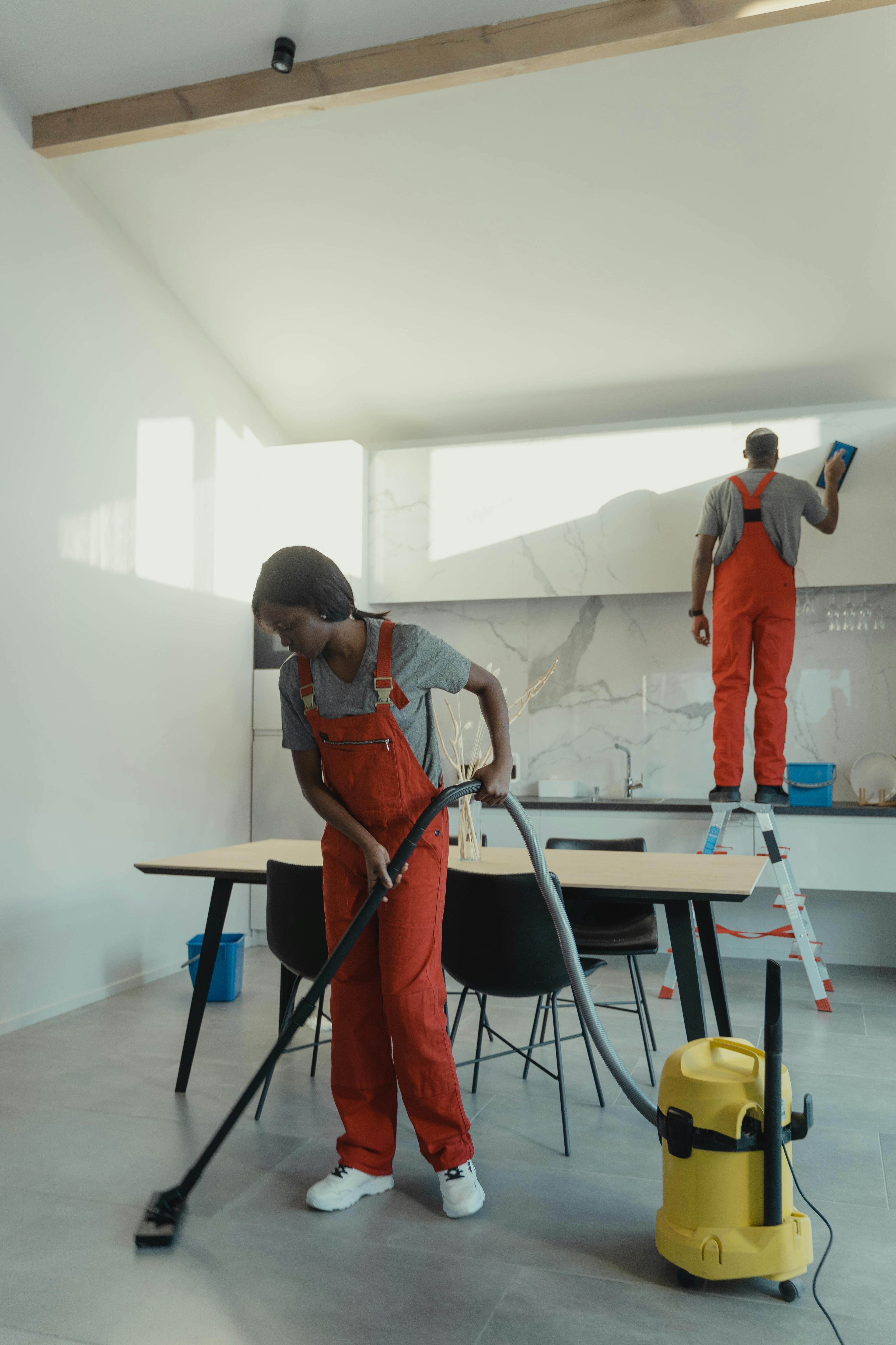 two cleaning staff cleaning an apartment